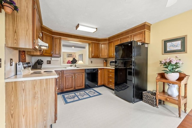 kitchen with black appliances, a sink, under cabinet range hood, and light countertops