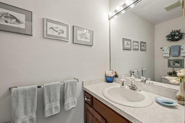 half bathroom featuring vanity and toilet