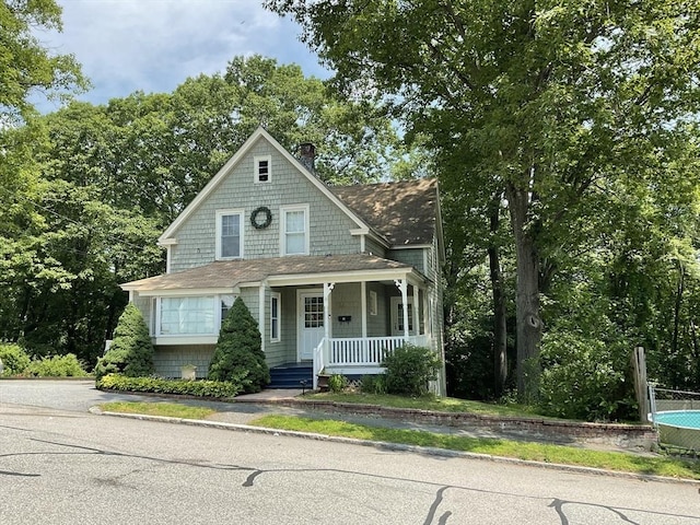 16 Knox St, Worcester, MA 01603 - shingle-style home with covered porch, a shingled roof, and a chimney
