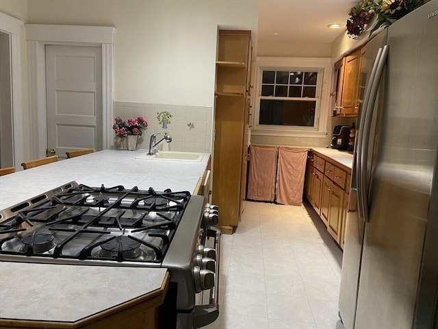 16 Knox St, Worcester, MA 01603 - kitchen with stainless steel fridge with ice dispenser, a sink, gas stove, brown cabinetry, and light countertops