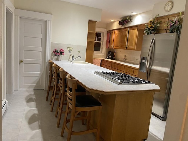 16 Knox St, Worcester, MA 01603 - kitchen with brown cabinetry, stainless steel appliances, light countertops, a sink, and recessed lighting