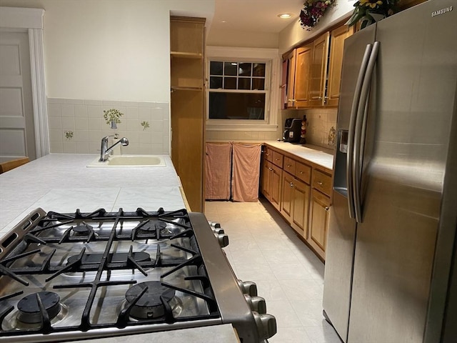 16 Knox St, Worcester, MA 01603 - kitchen featuring stainless steel fridge, a sink, brown cabinetry, cooktop, and light countertops