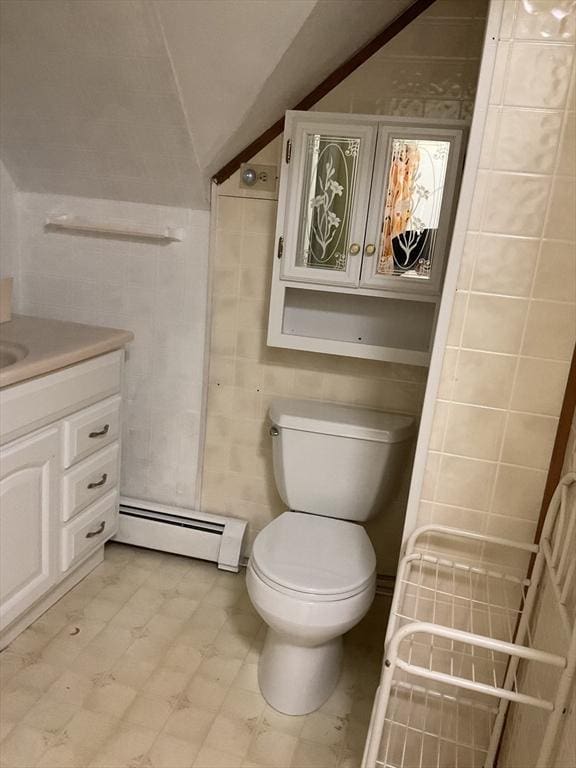 16 Knox St, Worcester, MA 01603 - bathroom with baseboard heating, tile walls, vanity, toilet, and lofted ceiling