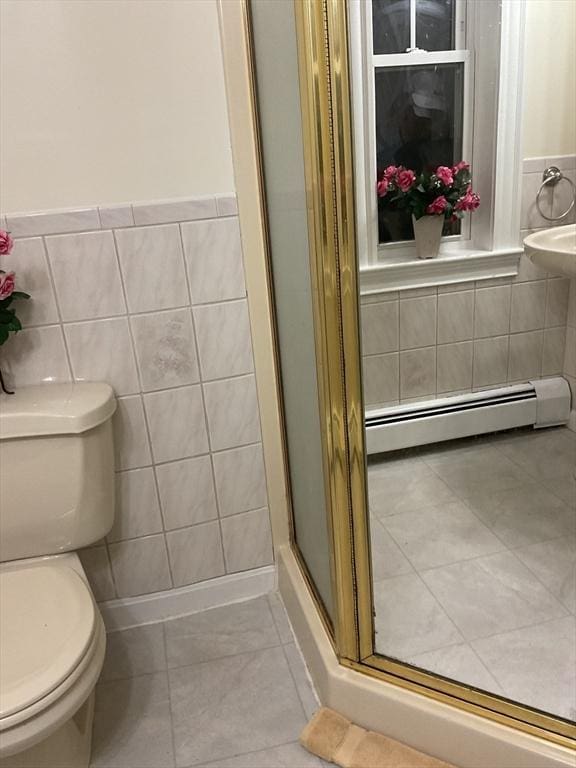 16 Knox St, Worcester, MA 01603 - bathroom with a baseboard radiator, tile walls, toilet, tile patterned floors, and a shower stall