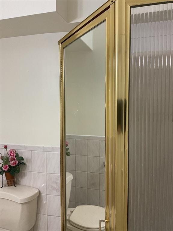 16 Knox St, Worcester, MA 01603 - bathroom featuring toilet, tile walls, and wainscoting