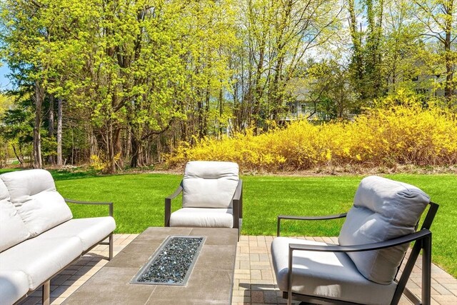 view of patio / terrace with an outdoor living space with a fire pit