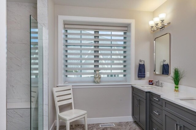 full bath with double vanity, visible vents, a sink, baseboards, and tiled shower