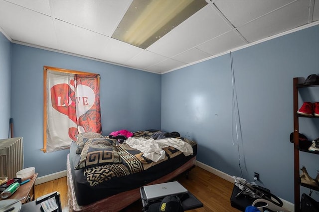 bedroom with baseboards and wood finished floors