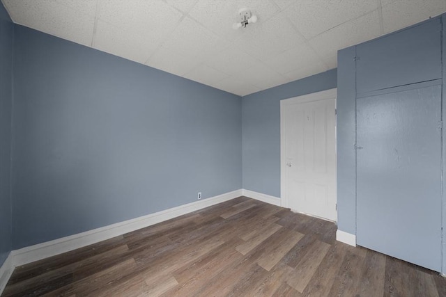 spare room with dark wood finished floors and baseboards