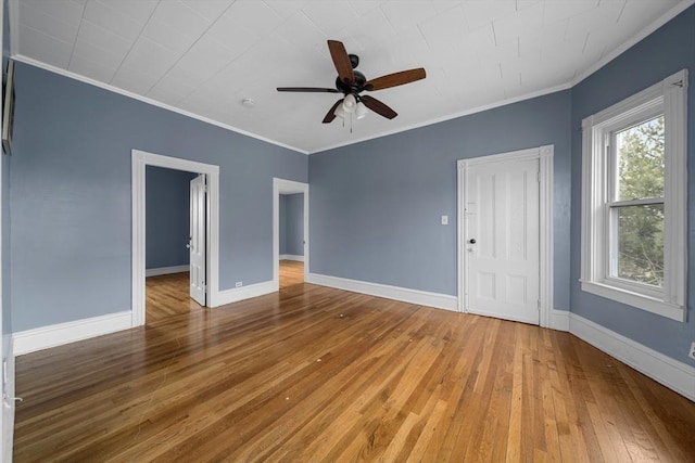 unfurnished room with baseboards, a ceiling fan, ornamental molding, and wood-type flooring