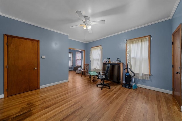 office with baseboards, a healthy amount of sunlight, and wood-type flooring