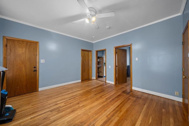 unfurnished bedroom with a closet, crown molding, baseboards, ceiling fan, and wood-type flooring