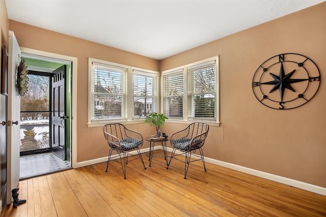 living area with baseboards and light wood finished floors