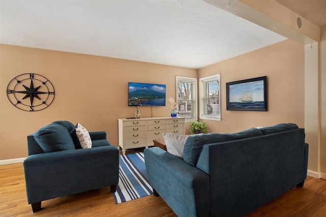 living room with light wood-type flooring and baseboards