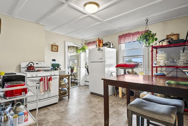 kitchen featuring white appliances and plenty of natural light