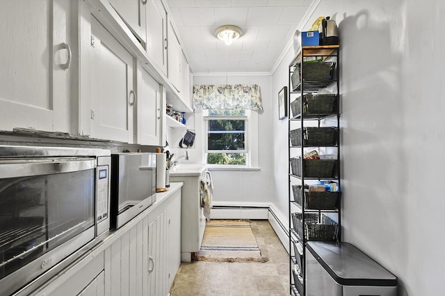 spacious closet with baseboard heating and light tile patterned floors
