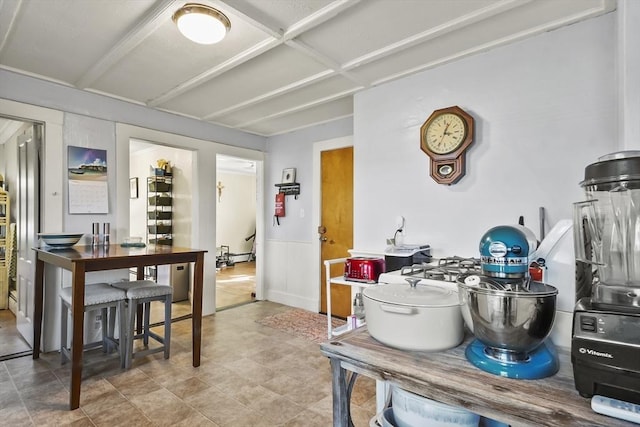dining space featuring wainscoting