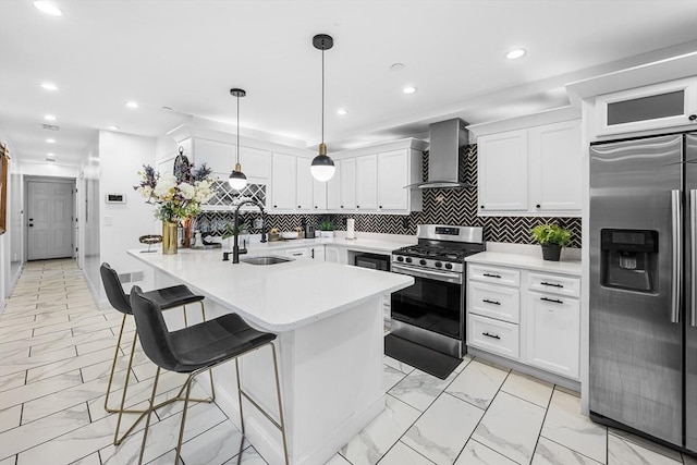 kitchen featuring stainless steel appliances, a sink, light marble finish floors, wall chimney range hood, and recessed lighting