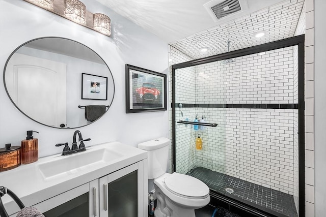 bathroom featuring a stall shower, toilet, and vanity