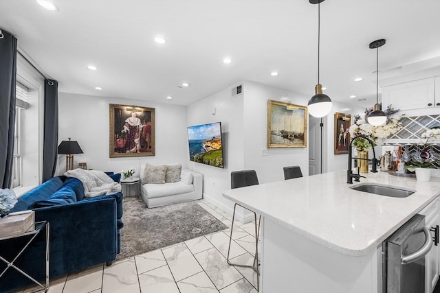 living room with light marble finish floors, recessed lighting, and baseboards