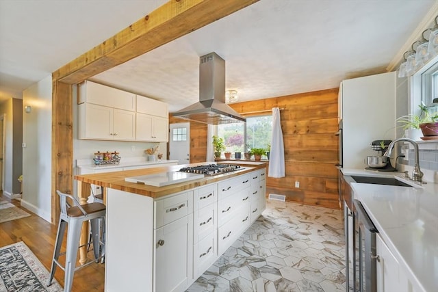 62 Greenbrier Dr, New Bedford, MA 02745 - kitchen with island range hood, a sink, wine cooler, stainless steel appliances, and white cabinets