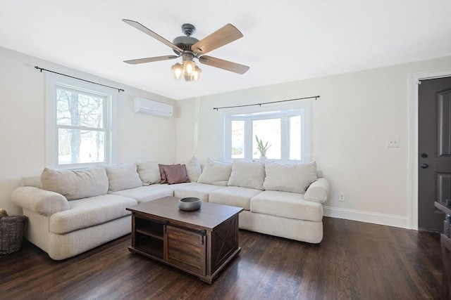 living area featuring dark wood-style floors, baseboards, a wealth of natural light, and a wall mounted AC