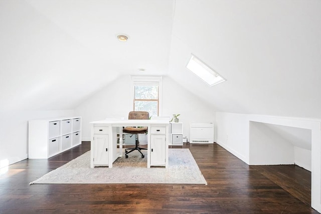 home office with vaulted ceiling with skylight and dark wood-style flooring