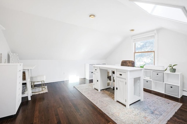 home office with lofted ceiling with skylight and dark wood finished floors