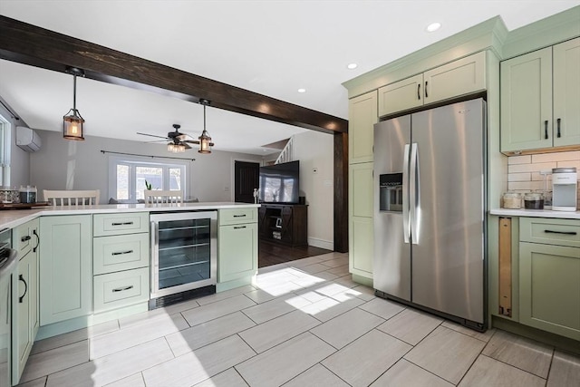 kitchen with light countertops, beverage cooler, stainless steel fridge, and green cabinetry