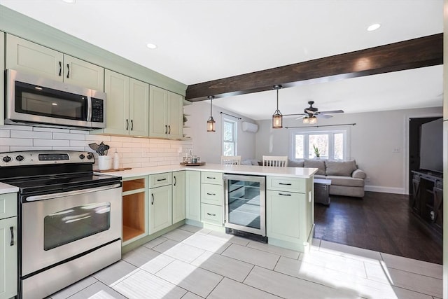 kitchen featuring appliances with stainless steel finishes, light countertops, and green cabinetry