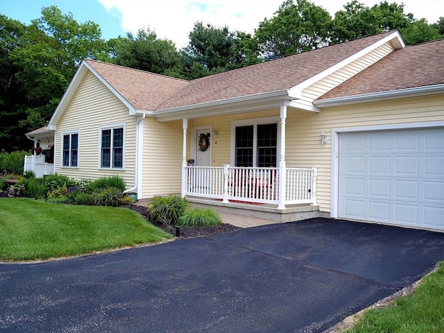4 Bluebird Ln Unit 4, Killingly, CT 06241 - ranch-style home featuring covered porch, an attached garage, roof with shingles, and a front yard