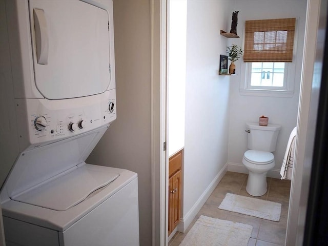 4 Bluebird Ln Unit 4, Killingly, CT 06241 - laundry room with stacked washing machine and dryer, light tile patterned flooring, and baseboards
