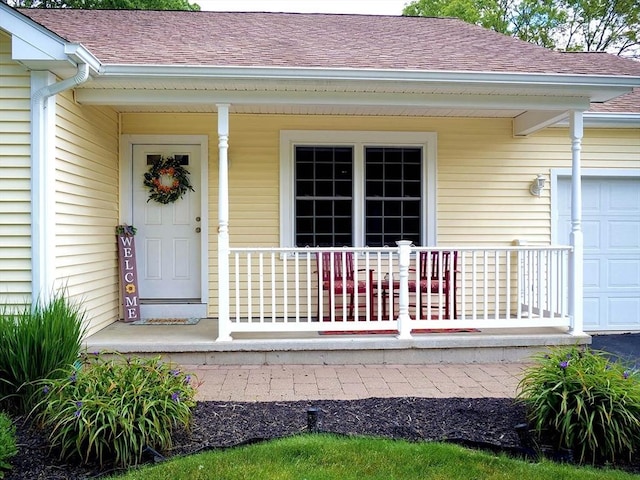 4 Bluebird Ln Unit 4, Killingly, CT 06241 - doorway to property featuring a porch, roof with shingles, and an attached garage
