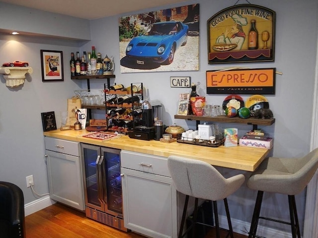 4 Bluebird Ln Unit 4, Killingly, CT 06241 - indoor dry bar featuring wine cooler, wood finished floors, and baseboards