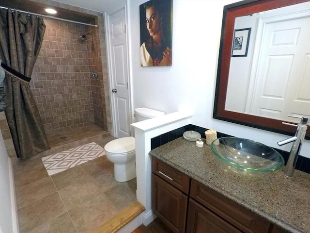 4 Bluebird Ln Unit 4, Killingly, CT 06241 - bathroom featuring toilet, vanity, a tile shower, and tile patterned floors