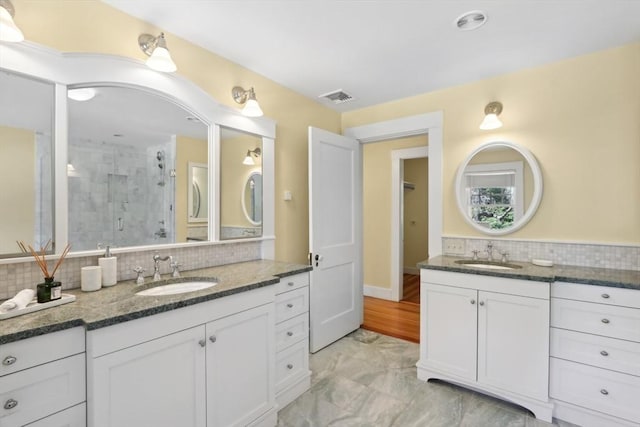 10 Orchard Rd, Gloucester, MA 01930 - full bathroom featuring tasteful backsplash, a shower stall, and two vanities