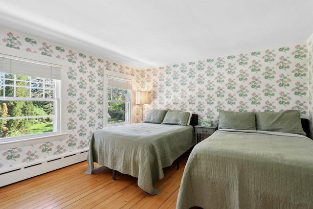 10 Orchard Rd, Gloucester, MA 01930 - bedroom with wallpapered walls, baseboard heating, and light wood finished floors