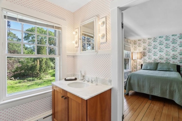 10 Orchard Rd, Gloucester, MA 01930 - bathroom featuring wallpapered walls, vanity, hardwood / wood-style floors, and ensuite bathroom
