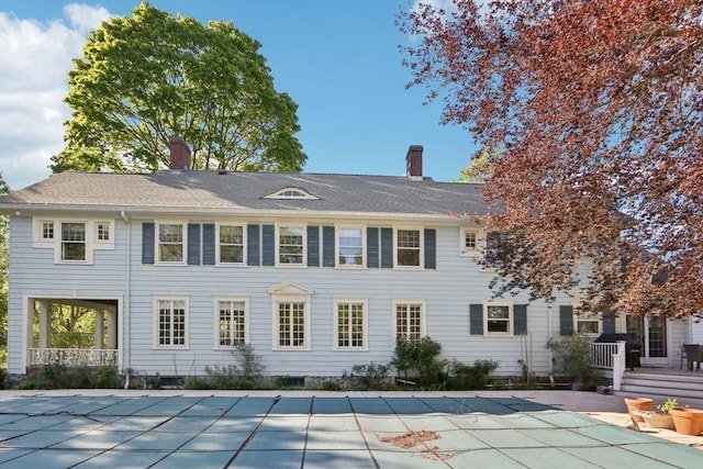 10 Orchard Rd, Gloucester, MA 01930 - rear view of property with a chimney, a covered pool, and a patio