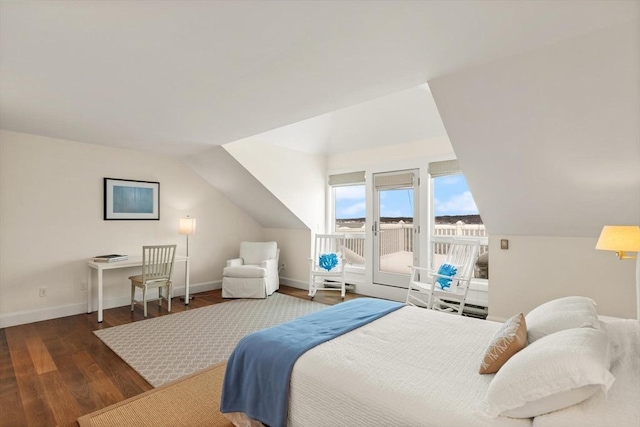 bedroom with access to exterior, vaulted ceiling, baseboards, and wood finished floors