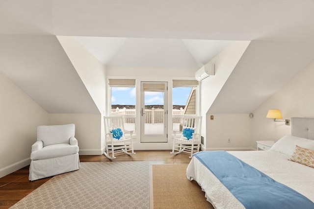 bedroom featuring access to exterior, an AC wall unit, lofted ceiling, and wood finished floors