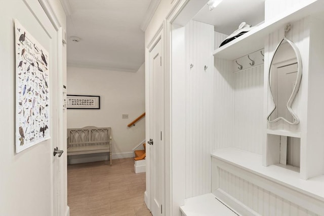 mudroom featuring baseboards and light wood finished floors