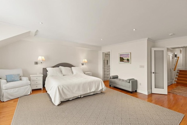 bedroom with recessed lighting, wood finished floors, and ornamental molding