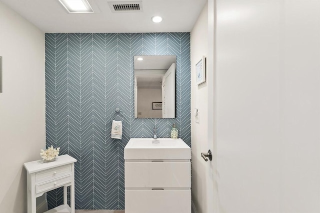 bathroom featuring visible vents, recessed lighting, and vanity