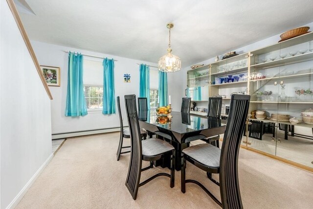 dining area with an inviting chandelier, baseboards, light colored carpet, and a baseboard radiator