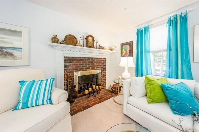 living area with a fireplace and brick floor