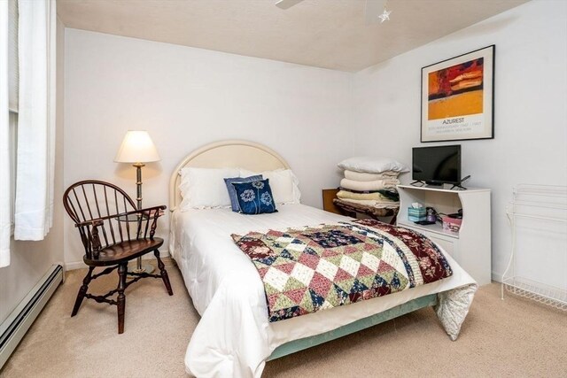 bedroom featuring light colored carpet and a baseboard radiator