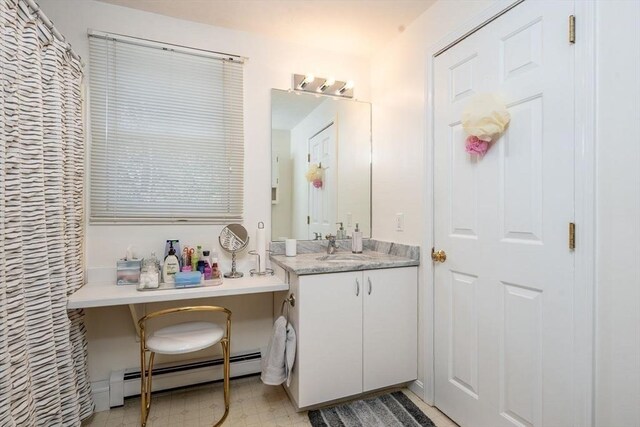 bathroom with baseboard heating, tile patterned floors, and vanity