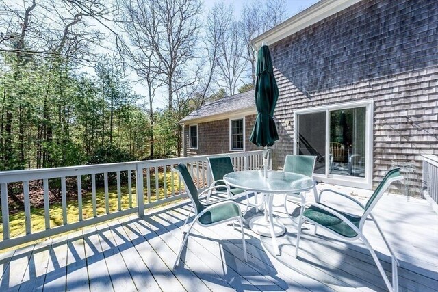 wooden terrace featuring outdoor dining area