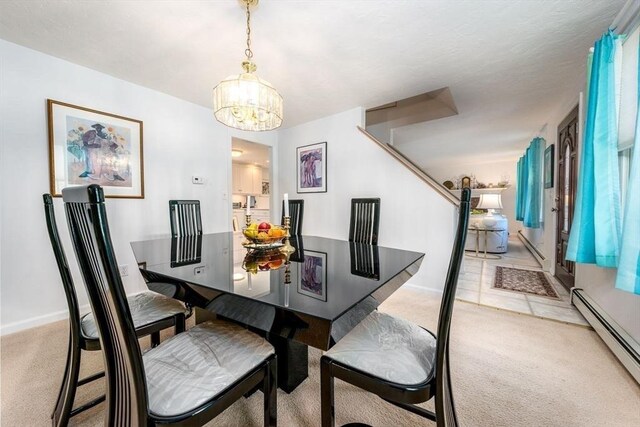 dining area with light colored carpet, a baseboard radiator, baseboards, stairway, and a notable chandelier